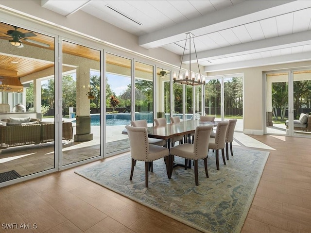 sunroom with beam ceiling and ceiling fan with notable chandelier