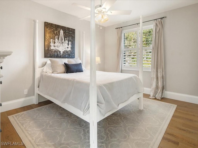 bedroom with ceiling fan and hardwood / wood-style flooring