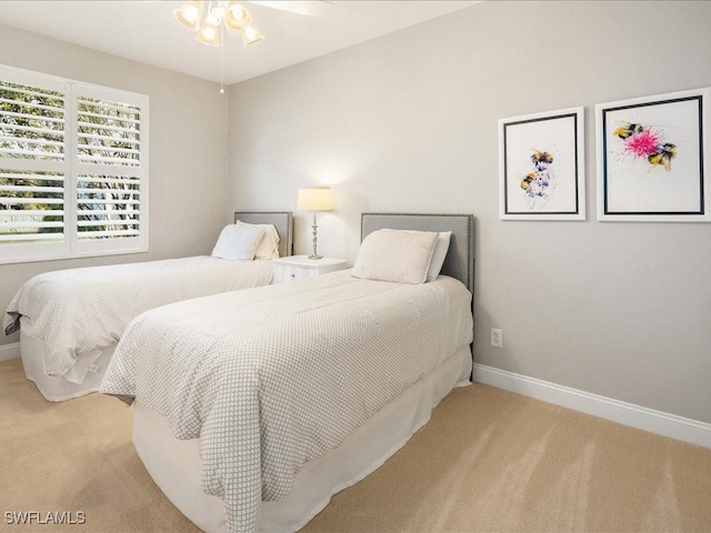 bedroom with light carpet and ceiling fan