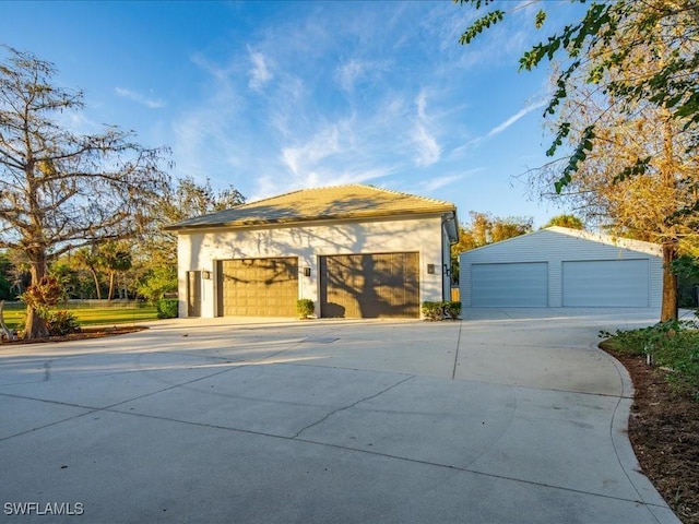 view of front of home with an outdoor structure and a garage