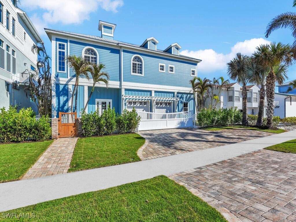 view of front of home featuring a garage, decorative driveway, and a front lawn