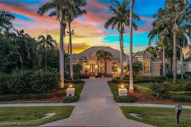 mediterranean / spanish-style house featuring a lawn