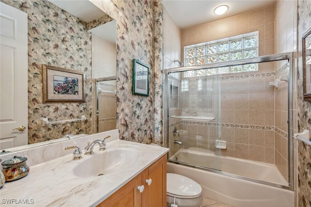 full bathroom with vanity, toilet, and enclosed tub / shower combo