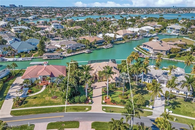 birds eye view of property featuring a water view and a residential view