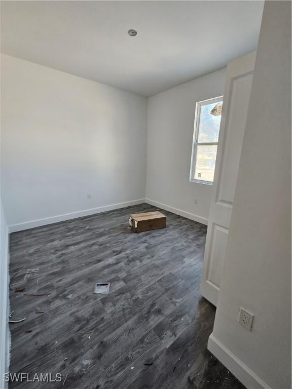 spare room featuring dark hardwood / wood-style floors