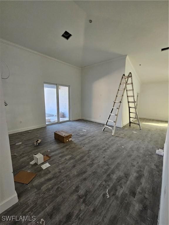 empty room featuring ornamental molding and dark wood-type flooring