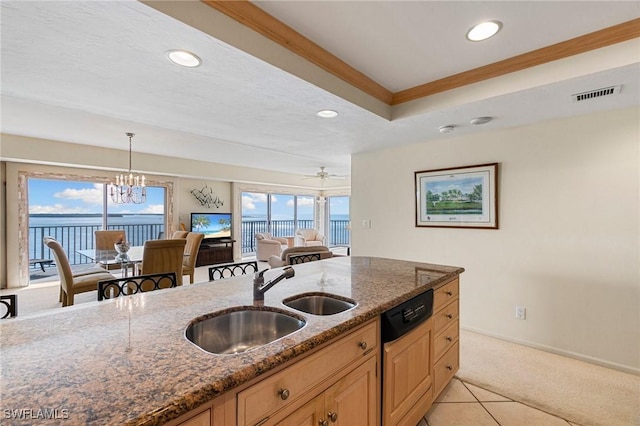 kitchen with dishwasher, ceiling fan with notable chandelier, sink, dark stone countertops, and decorative light fixtures