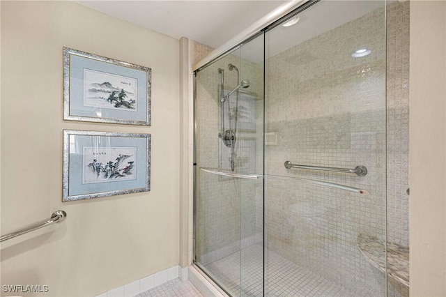 bathroom with tile patterned flooring and walk in shower