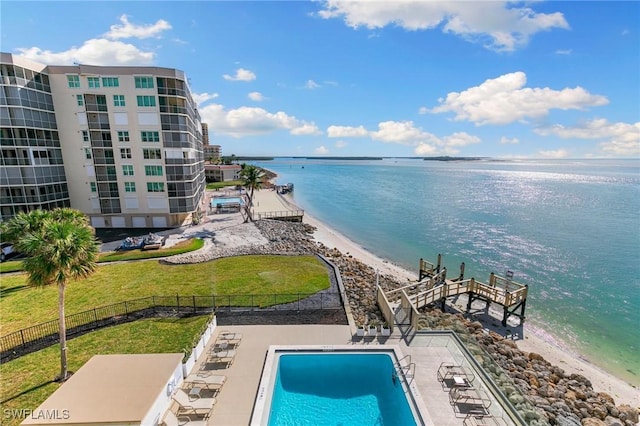 exterior space with a patio area, a water view, and a view of the beach