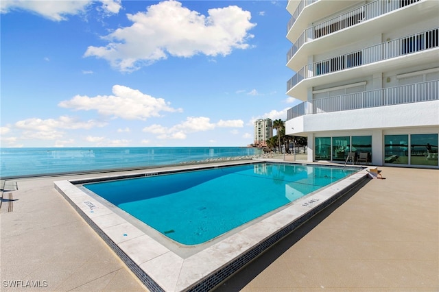 view of swimming pool with a water view