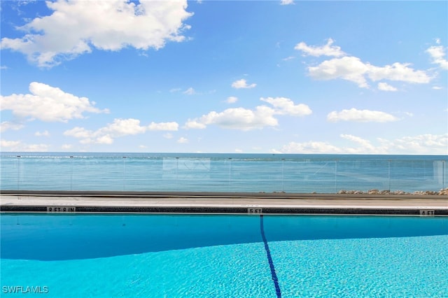 view of pool with a water view