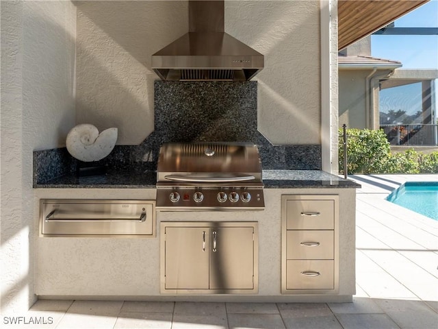 view of patio with area for grilling and a grill