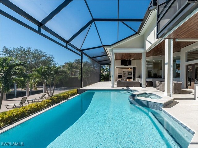 view of pool with an in ground hot tub, an outdoor hangout area, a patio, ceiling fan, and glass enclosure