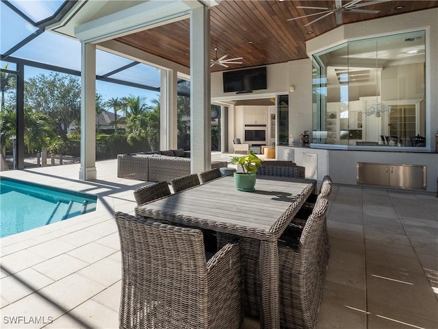 view of swimming pool featuring an outdoor living space with a fireplace, ceiling fan, and a patio area