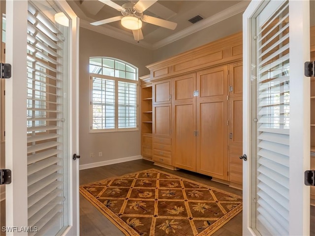 foyer featuring ceiling fan, ornamental molding, and dark hardwood / wood-style flooring