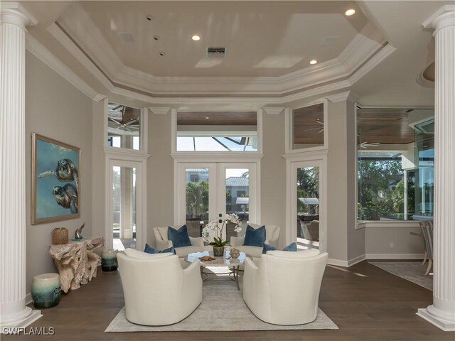 living room with french doors, a raised ceiling, ceiling fan, a high ceiling, and dark hardwood / wood-style flooring