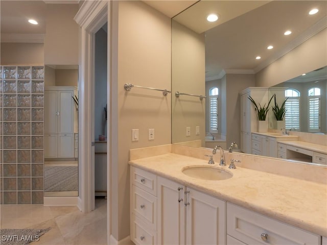 bathroom with tile patterned flooring, crown molding, and vanity