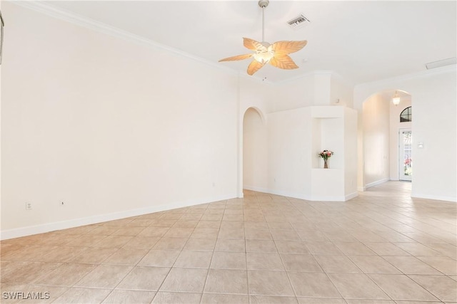 tiled spare room with ceiling fan and crown molding