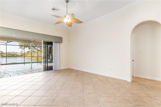 tiled empty room featuring ceiling fan, a water view, and ornamental molding