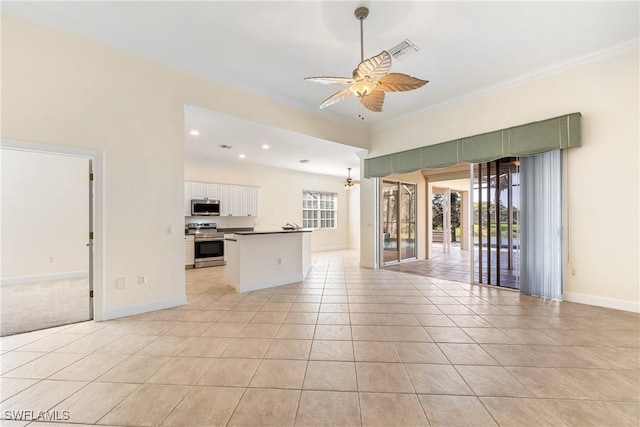 interior space featuring ceiling fan with notable chandelier, light tile patterned flooring, and crown molding