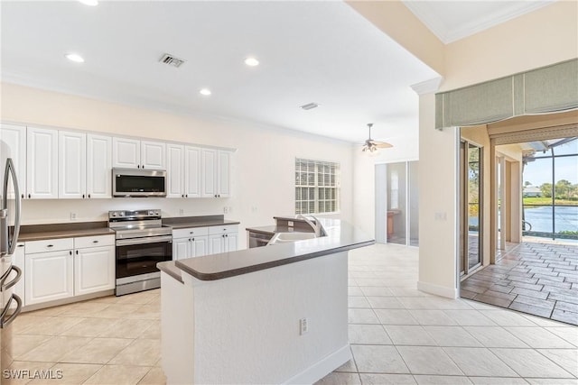 kitchen with white cabinetry, sink, ceiling fan, light tile patterned flooring, and appliances with stainless steel finishes