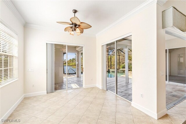 tiled empty room with ceiling fan and crown molding