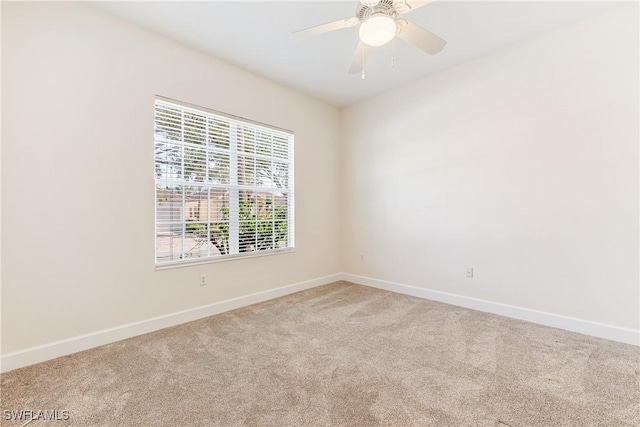 carpeted empty room with ceiling fan and a healthy amount of sunlight