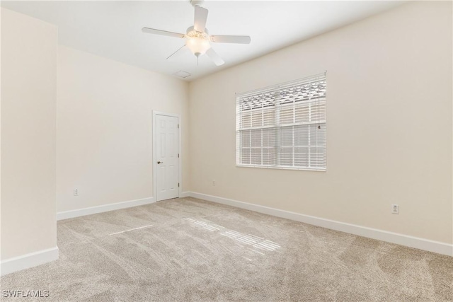 spare room featuring ceiling fan and light colored carpet