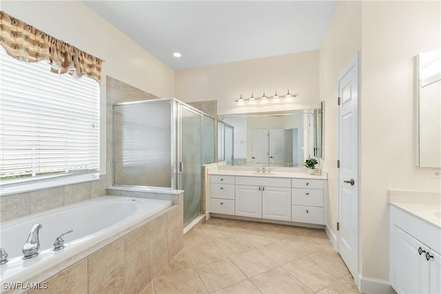 bathroom featuring tile patterned floors, vanity, and separate shower and tub