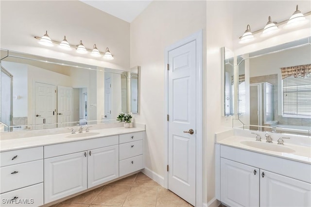 bathroom featuring tile patterned floors, vanity, and shower with separate bathtub