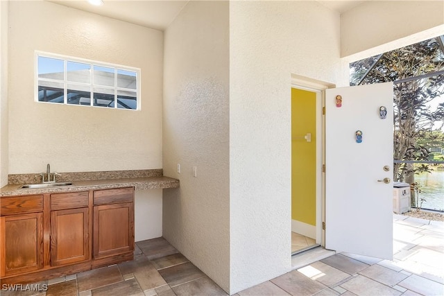 exterior space featuring a wealth of natural light and sink