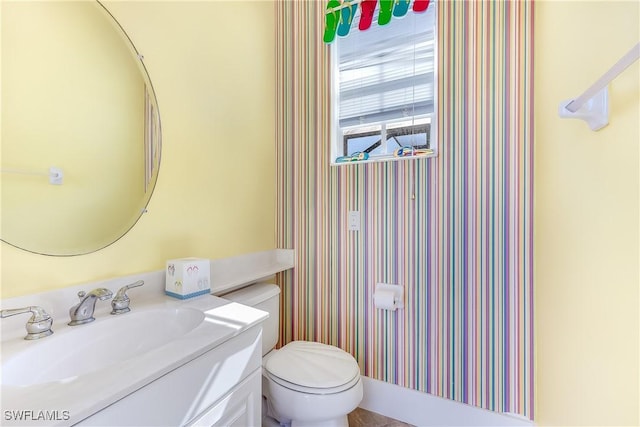 bathroom featuring vanity and toilet