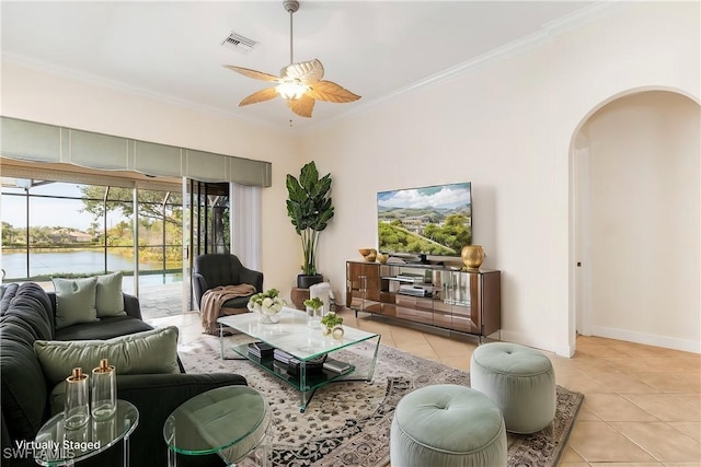 living room featuring ceiling fan, a water view, light tile patterned floors, and ornamental molding