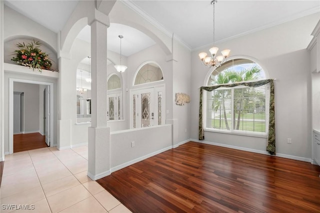 interior space with crown molding and an inviting chandelier