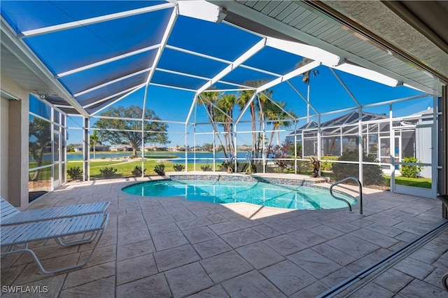 view of pool with a patio and glass enclosure