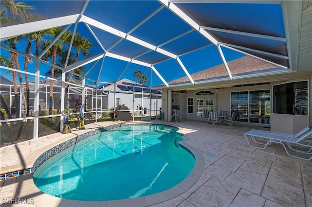 view of pool with a lanai and a patio area