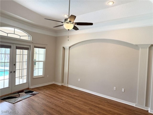 13028 Kingsway Cir SW, Lake Suzy, FL 34269 - doorway with ornate columns, dark wood-style flooring, ceiling fan, french doors, and crown molding