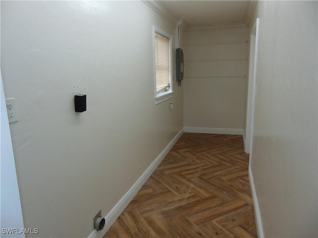 hallway with dark parquet flooring and ornamental molding