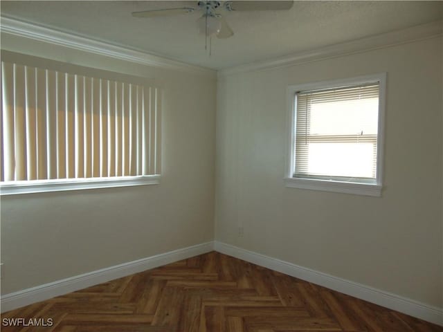 empty room featuring dark parquet floors, ceiling fan, and ornamental molding