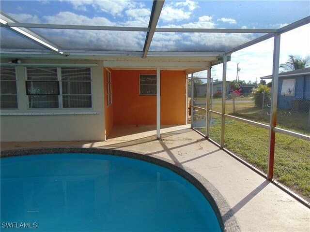 view of swimming pool with a lanai and a patio area