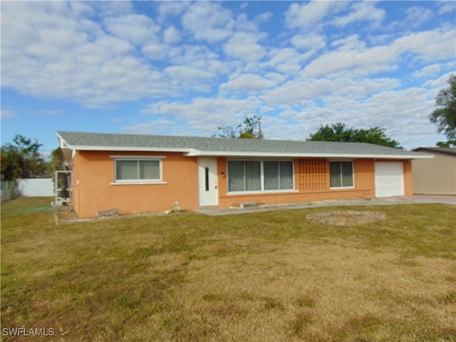 ranch-style house with a garage and a front lawn