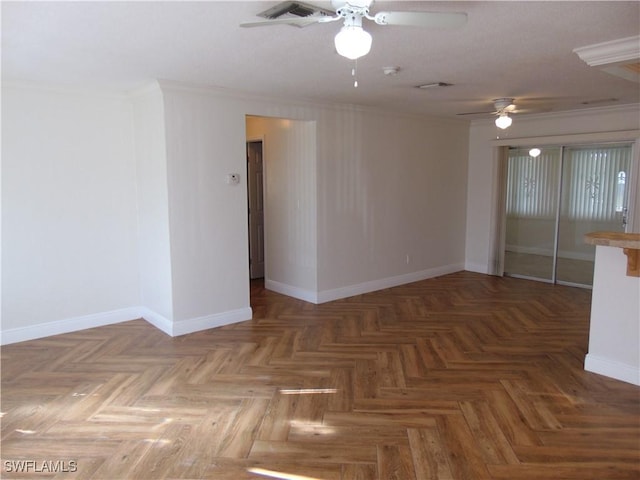 spare room with ceiling fan, parquet flooring, and ornamental molding