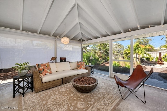 sunroom / solarium with vaulted ceiling with beams