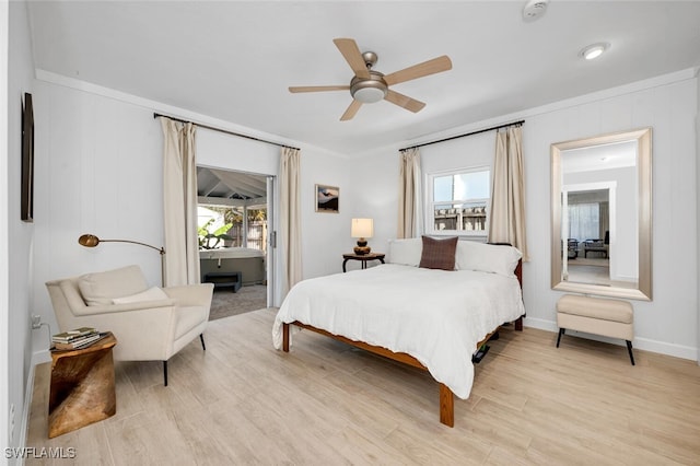 bedroom with ceiling fan, light wood-type flooring, crown molding, and multiple windows