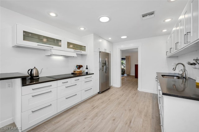 kitchen with stainless steel fridge with ice dispenser, sink, and white cabinets