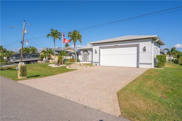 ranch-style home featuring a garage and a front lawn