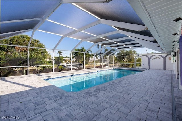 view of pool with a lanai and a patio area