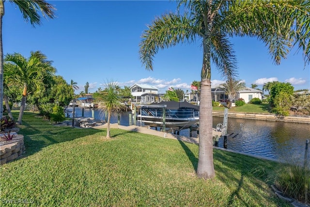 view of dock featuring a water view and a yard