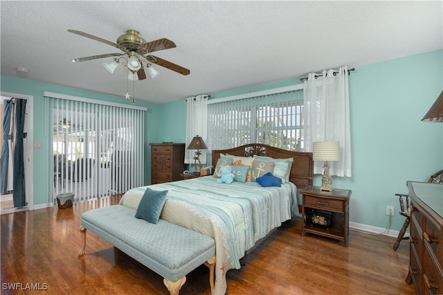 bedroom with ceiling fan, a textured ceiling, and multiple windows