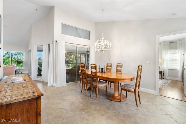 dining room featuring a notable chandelier, high vaulted ceiling, and light tile patterned floors